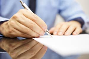 Businessman Is Writing A Letter Or Signing A Agreement